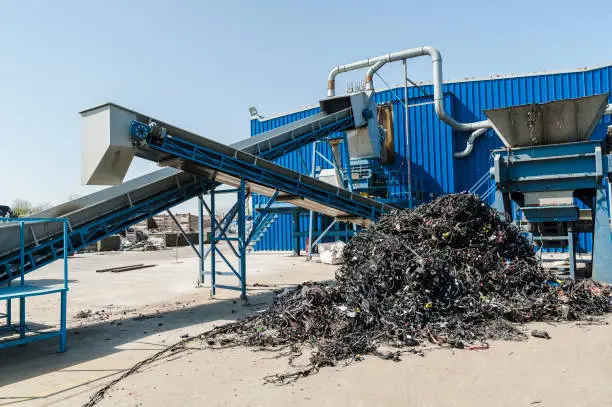 Plastic and rubber components resulted from cars disassembled are being shredded and separated during recycling process.