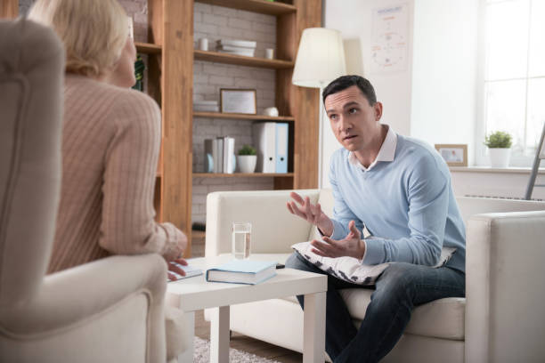 istock Stressed young man describing emotional state 951055072