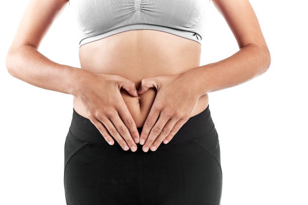 istock Female hands holding stomach in heart shape 951055382