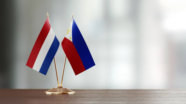 istock Dutch And Philippines Flag Pair On A Desk Over Defocused Background 951055876