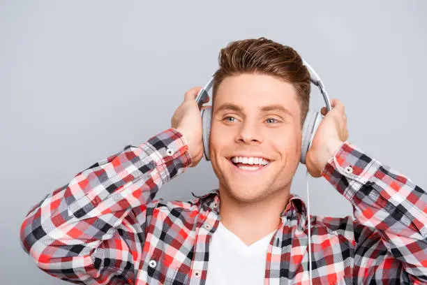 Photo of Portrait of happy young man  listening music in headphones
