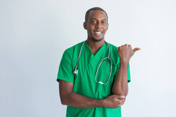 istock Portrait of smiling young physician pointing with thumb 951056426