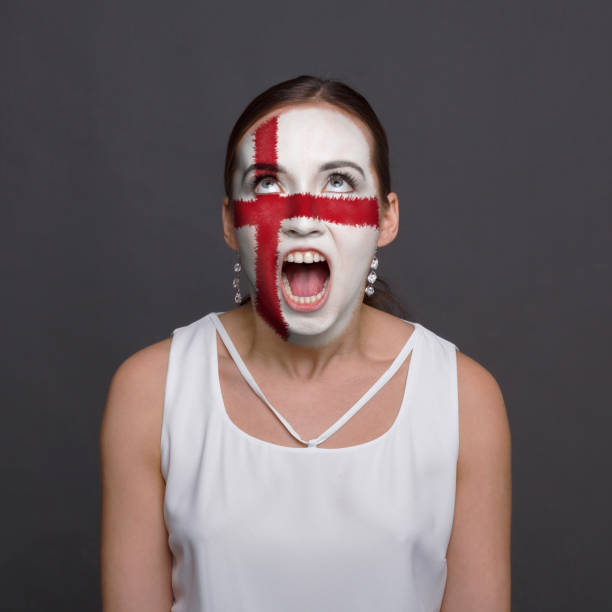 istock Young woman with England flag painted on his face 951059394