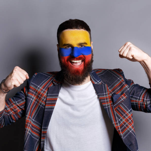 istock Young man with Columbia flag painted on his face 951059670