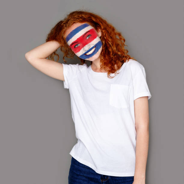 istock Young woman with Costa Rica flag painted on her face 951059708