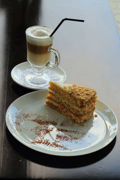 Dessert with sweet napoleon cake and cream coffee served at confectionery