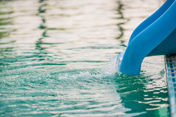 istock waterfall from water slide in the swimming pool 951060320