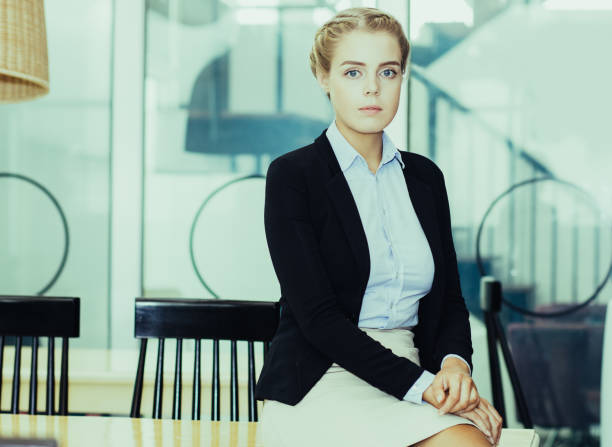 istock Serious Attractive Business Woman Sitting on Table 951061820
