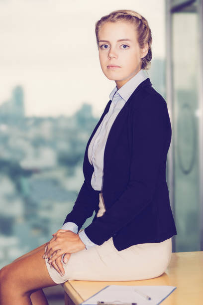 istock Serious Charming Business Lady Sitting on Table 951061824