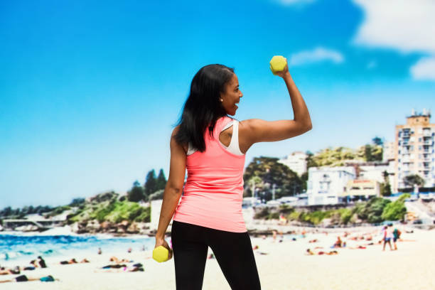 istock Happy female working out on beach in Sydney, Australia 951065438