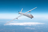 Unmanned military drone on patrol air territory at high altitude.