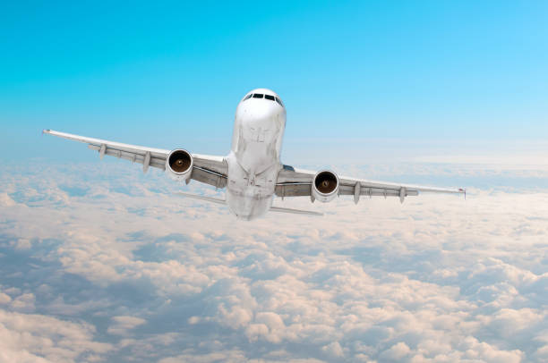 istock Passenger airplane flying at flight level high in the sky above the clouds. View directly in front, exactly. 951069842