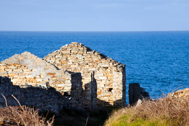 istock Old ruined stone house by the sea. 951073550