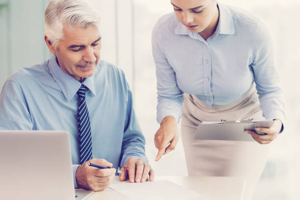 istock Senior Boss and Secretary Discussing Document 951073764