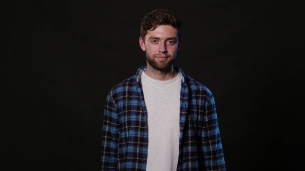 istock A Young Man Mimicing Against a Black Background 951074174