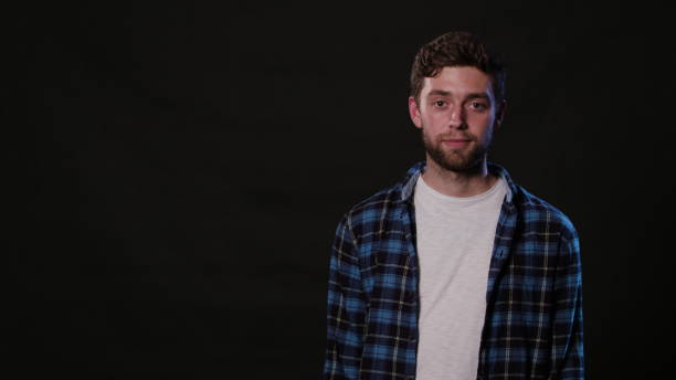 istock A Young Man Mimicing Against a Black Background 951074226