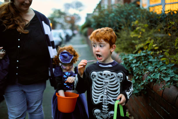 istock Little Boy Eating Halloween Candy 951074590