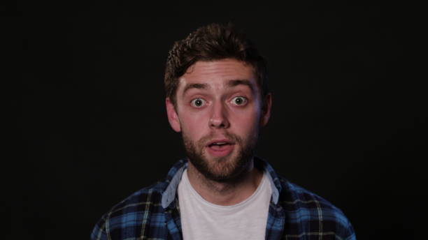 istock A Young Man Mimicing Against a Black Background 951077186