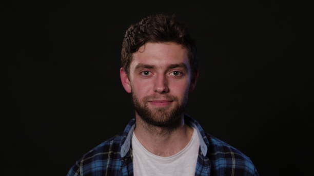 istock A Young Man Mimicing Against a Black Background 951077354