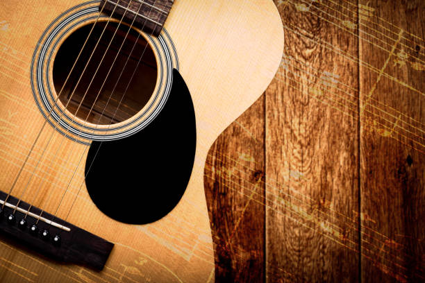 istock acoustic guitar on wood with music note 951077592