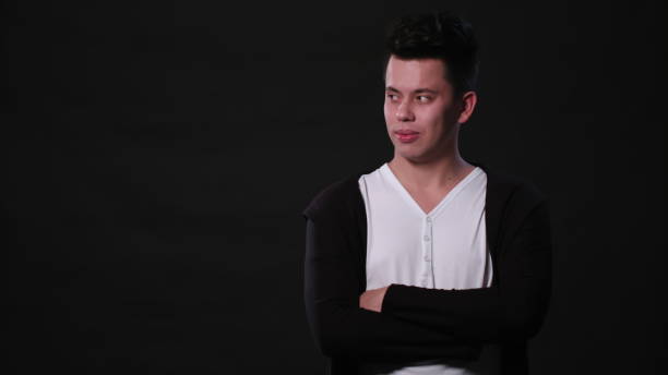 istock A Young Man Mimicing Against a Black Background 951078840