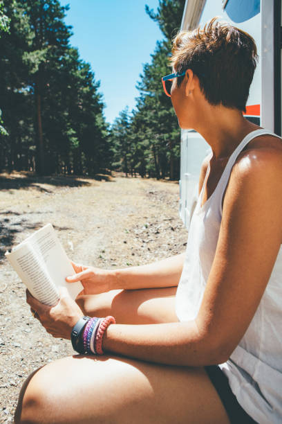 istock Girl enjoys the reading on a motor home 951081108