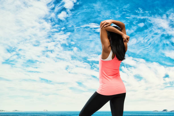 istock Cheerful female standing by the lake / ocean 951086718