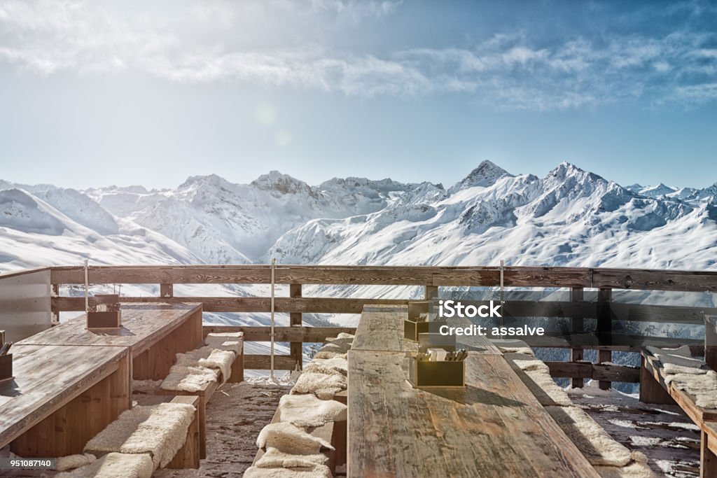 outdoor restaurant with spectacular view of swiss-alps on the Jakobshorn. The Jakobshorn is a very well-known ski area above Davos in Switzerland. Davos itself is known as a winter holiday destination and above all the annual World Economic Forum (WEF) takes place here. Restaurant Stock Photo