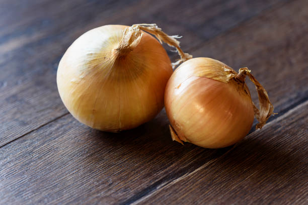 istock Onion on wooden background 951087336