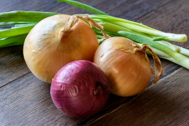 istock Different kinds of onions on a wooden background 951087484