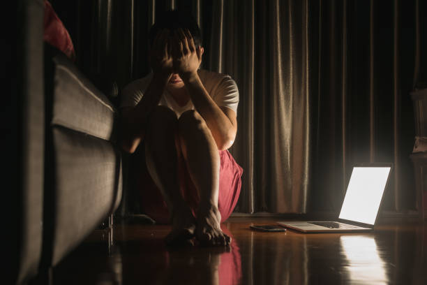 istock Man facing depression disorder sit on floor with laptop and smartphone beside, conceptual image showing effect from social media resulting in depression disorder 951088192
