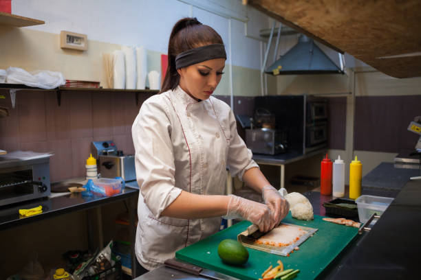istock woman in white chef prepares sushi restaurant 951088226