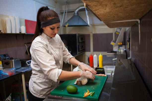 istock woman in white chef prepares sushi restaurant 951088376