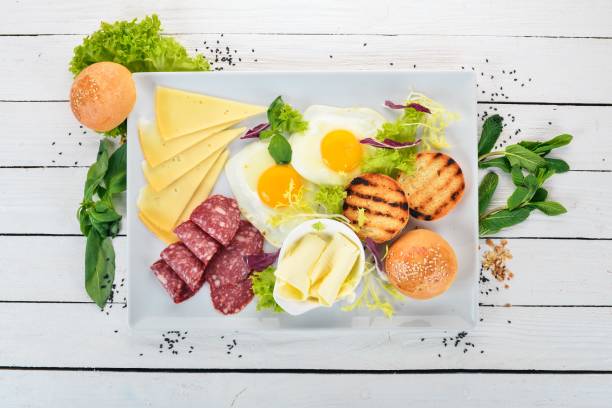 istock Breakfast. Eggs with bacon and tomatoes, toast bread. Top view. On a wooden background. Copy space. 951091036