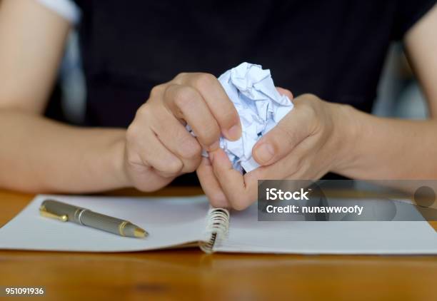 Crumpling The Sheet Of Paperwork Stock Photo - Download Image Now - Crumpled Paper Ball, Crumpled, Hand