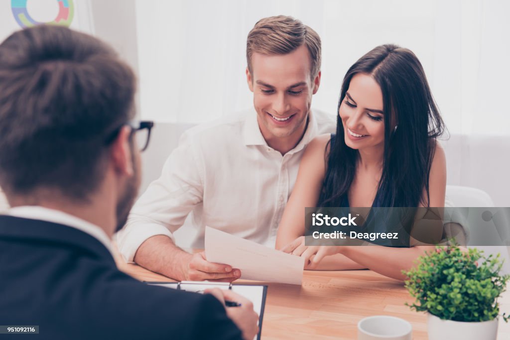 Successful lawyer giving consultation to family couple about buying house Advice Stock Photo