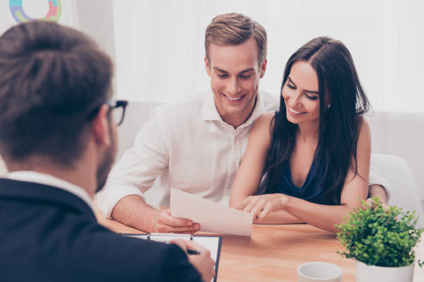 Successful lawyer giving consultation to family couple about buying house Successful lawyer giving consultation to family couple about buying house cpa offers stock pictures, royalty-free photos & images