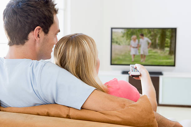 istock Couple in living room watching television 95109463