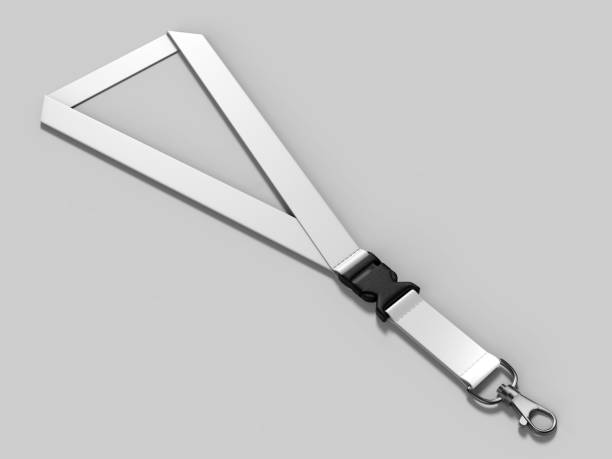 Small hanging key on string creating shadow on white background.