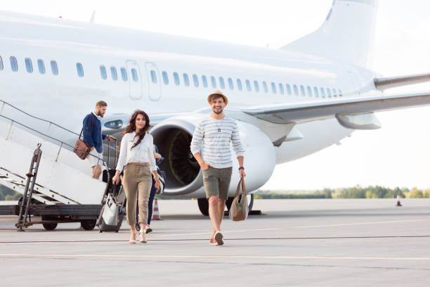 istock Young people getting out of airplane 951095820
