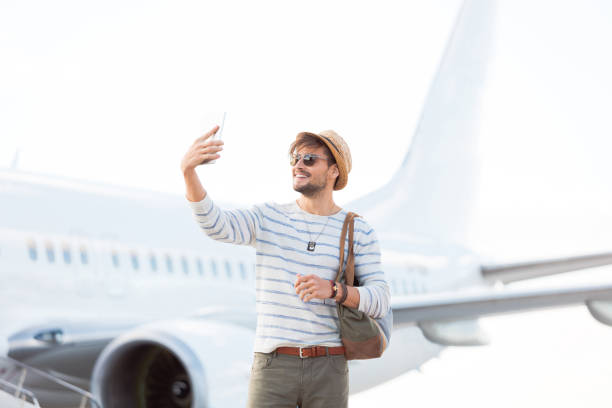 istock Tourist taking selfie at airport runway 951096390