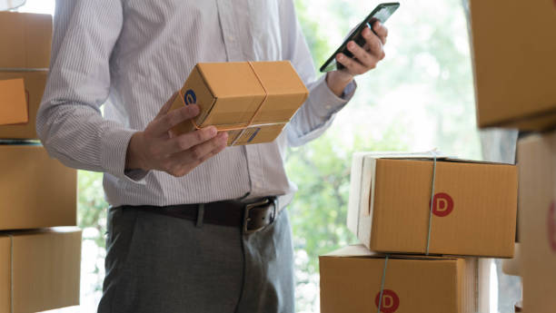istock Businessman use smartphone thinking with pile of parcel on work desk 951097130