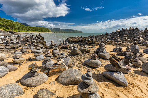 Stacked balancing rocks on the beach between Cairns and Port Douglas, Queensland, Australia