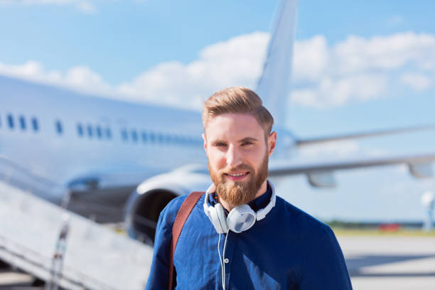 istock Handsome young man disembarking the airplane 951101338