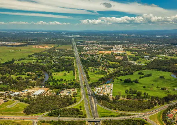 Aerial view of Caboolture and Bruce highway to Brisbane with Bribie Island Road crossing, Queensland, Australia