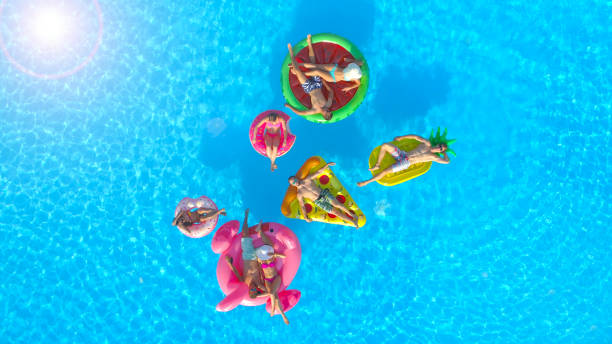 istock AERIAL: Cheerful fit people on summer vacation enjoying on fun inflatable floats 951105718