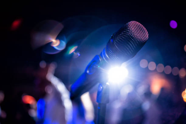 istock Close-up of a microphone against blurred lights 951109806