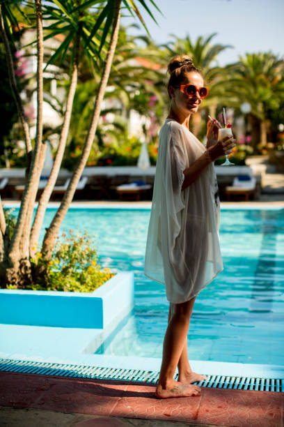 istock Young woman standing next to the pool 951110366