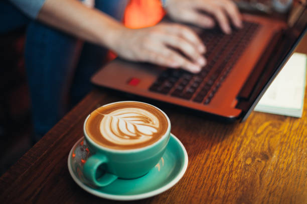 istock Woman using laptop and drinking coffee 951112748