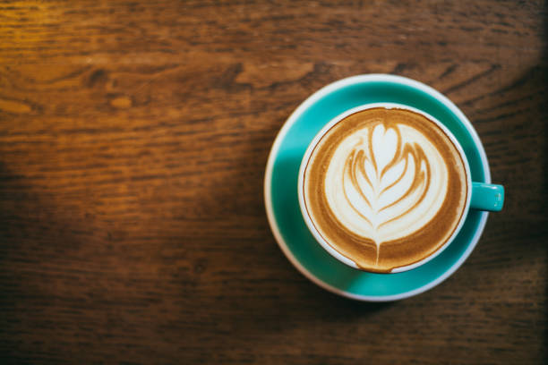 Cup of latte art coffee on wood table